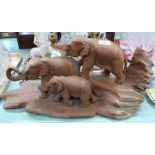 A carved wooden triple elephant group