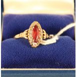 A 9ct gold ring set with red and white stones,