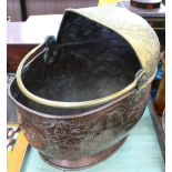 A 19th Century Dutch brass and copper coal helmet with Friesland arms and figure decoration