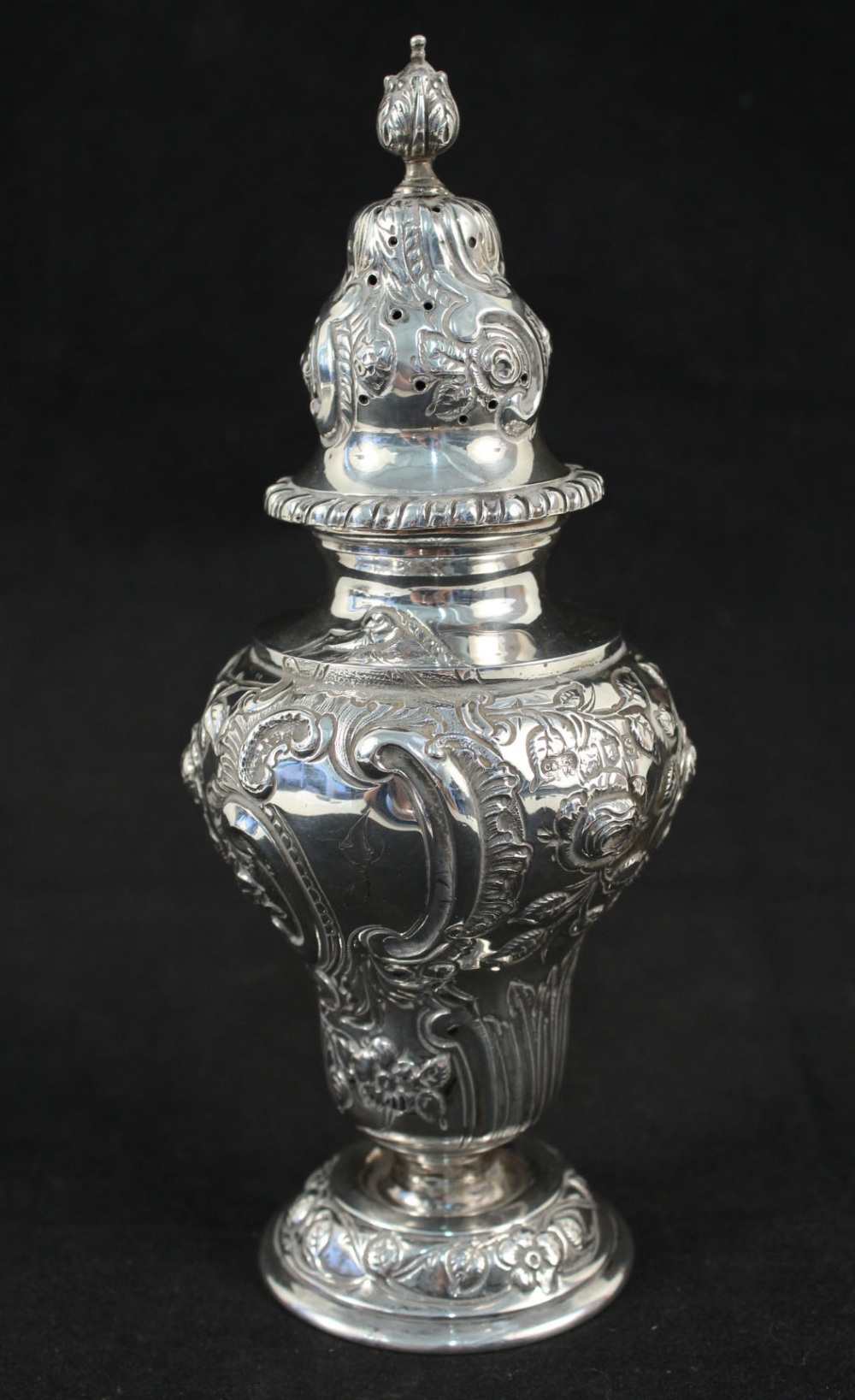 A silver floral embossed sugar caster,