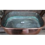 A heavy 19th Century oblong twin drop handled seamed copper roasting pan,