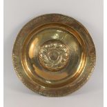 A heavy 16th Century Nuremberg brass alms dish with raised and gadrooned central roundel encircled
