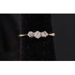 An 18ct gold three stone diamond ring,