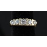 A Victorian style 18ct gold five stone diamond ring interspersed with smaller diamonds in fancy