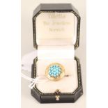 An unmarked large ring set with turquoise cluster to centre, rope style decoration to outer,