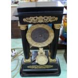 A French ebonised and gilt metal Empire style mantel clock