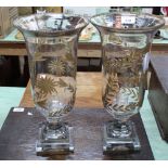 A pair of glass candle holders with gilt floral decoration