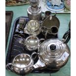 A small ornate silver plated oil lamp, three piece tea set,