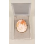 A yellow metal framed cameo brooch decorated with family scene