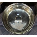 A heavy 18th Century deep brass bowl with raised central boss and ring turnings,