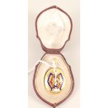 An 18ct gold pendant photo locket with applied enamelled initials to front and glass panel to