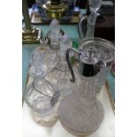 A set of three cut glass decanters, two claret jugs,