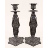 A pair of 19th Century brass Egyptian revival candlesticks
