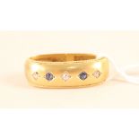 A 15ct gold scarf clip set with sapphire and diamonds