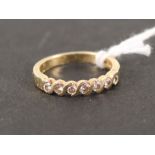 An 18ct gold ring set with seven diamonds,