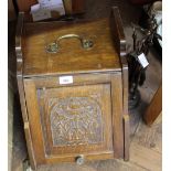 An Edwardian carved oak coal box, brass trivet,