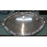 A large silver plated shaped edge tray with family crest