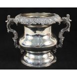 A silver plated wine cooler with vine leaf decoration and inscription