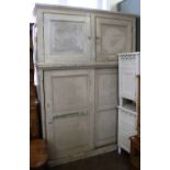 A substantial 19th Century white painted cupboard with two cupboard doors over two sliding door