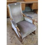 A 19th Century oak velour upholstered rocking chair