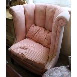 An unusual salmon pink upholstered high back tub chair