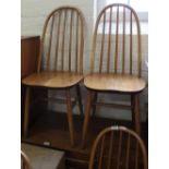 A set of four light Ercol style beech and elm hoop back chairs