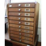 A vintage teak collector's cabinet with ten drawers