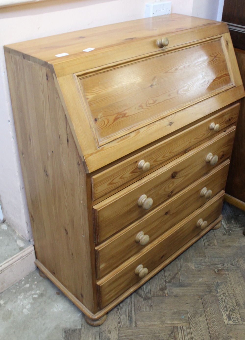 A modern pine four drawer bureau