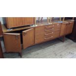 A long vintage teak four drawer, four door sideboard,