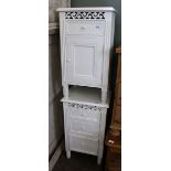 A pair of modern white painted bedside cabinets with fretwork decoration