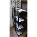 A pair of modern black wrought iron and tiled free standing shelves