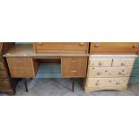A 1970's Roseberry of London four drawer oak and teak desk/dressing table on tapered legs and a
