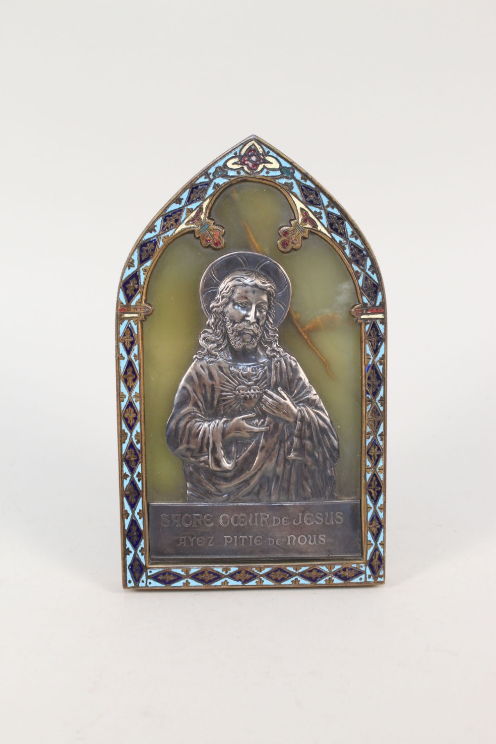 A 19th Century French champleve enamel, white metal and onyx easel plaque of Christ,