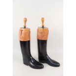 A pair of black riding boots with 'Count Fries' shoe trees,