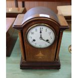 An Edwardian inlaid mahogany striking mantel clock