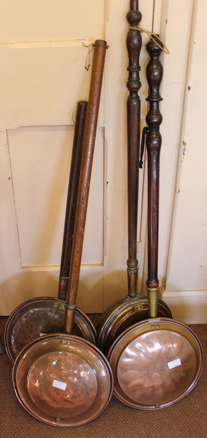 Four Victorian copper and brass warming pans