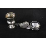 A continental silver straining spoon with bird and floral design and a white metal Kiddush cup plus