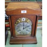 An oak striking mantel clock,