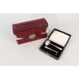 A red leather covered box with silver corners, London 1902 with a cased silver christening set,