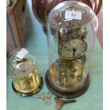 Two glass dome clocks