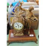 A gilt spelter and rouge marble man and dove decorated mantel clock