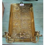 A brass double wall sconce with floral decoration