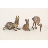 Two cold painted bronze hares plus a wading bird