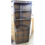 A dark Ercol style corner cupboard