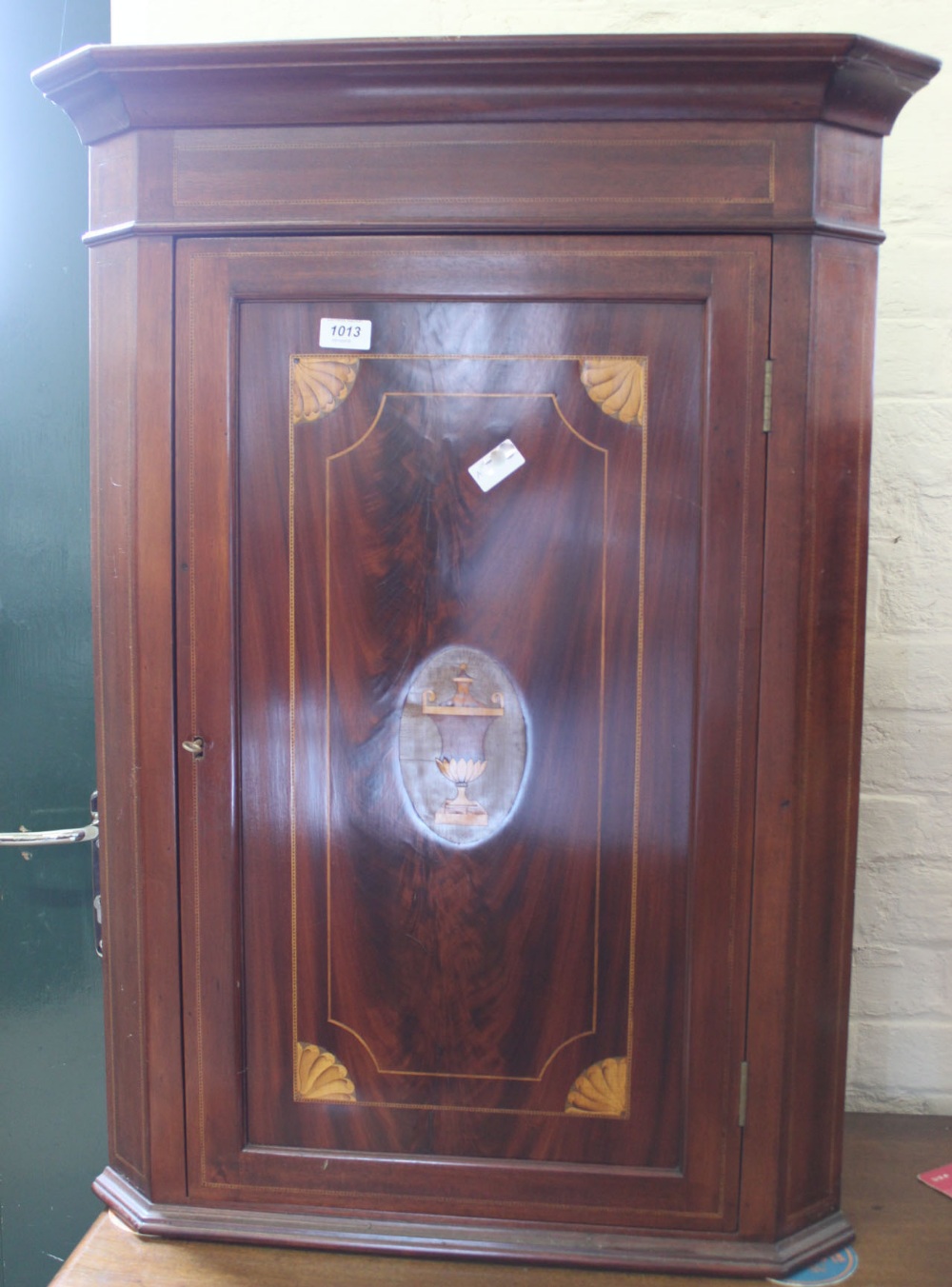 An Edwardian mahogany inlaid hanging corner cupboard