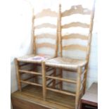 A drop leaf kitchen table and two ladder back rush seat chairs