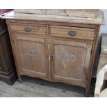 An Edwardian pine two door two drawer country cottage cupboard
