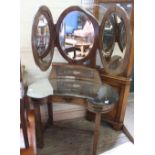 An unusual Arts and Crafts kidney shaped dressing table with triple oval mirror