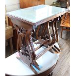 A nest of three leather topped tables with carved lyre ends and a loom style chair