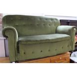 A green velour button back two seater sofa